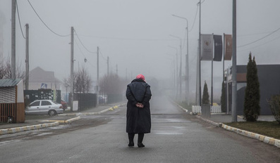 A local woman walks along an empty street in Ukraine